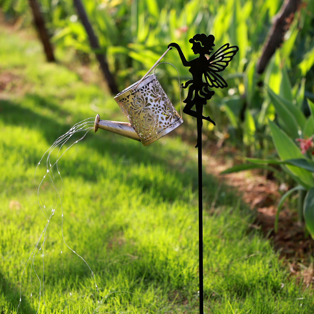Solar fairy lawn lamp with bronze lantern, thin hanging cord, and black winged figure stake