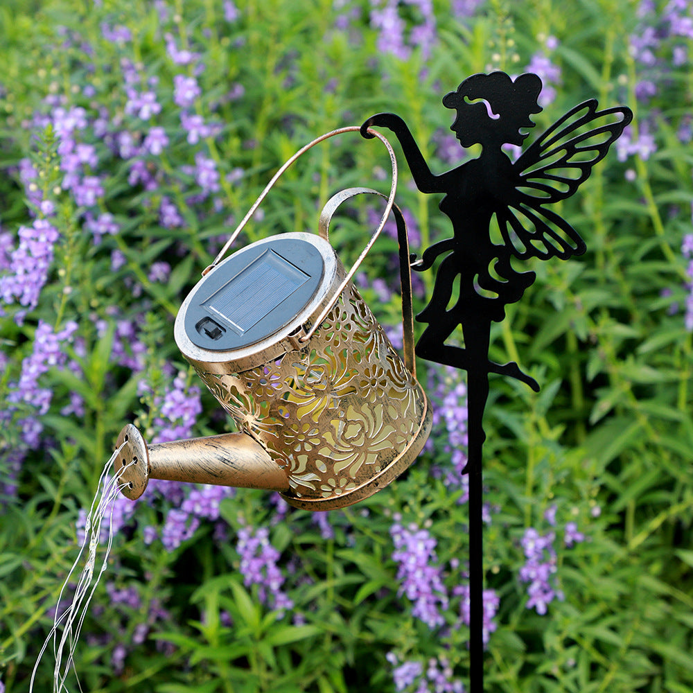 Solar garden projection lamp with bronze lantern, gold filigree pattern, and black fairy topper