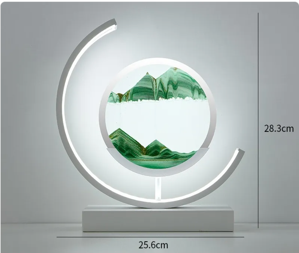 Hourglass table lamp with LED crescent ring and green landscape glass panel