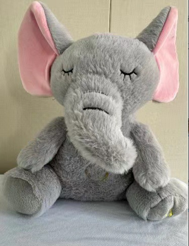Grey elephant plush music toy with closed eyes and long ears