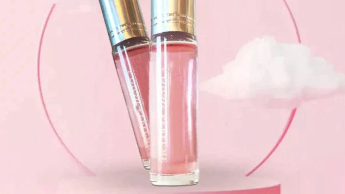 Pink perfume roller bottle with silver cap, close-up view