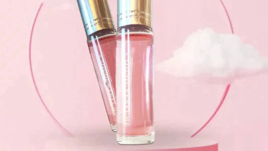 Pink perfume roller bottle with silver cap, close-up view