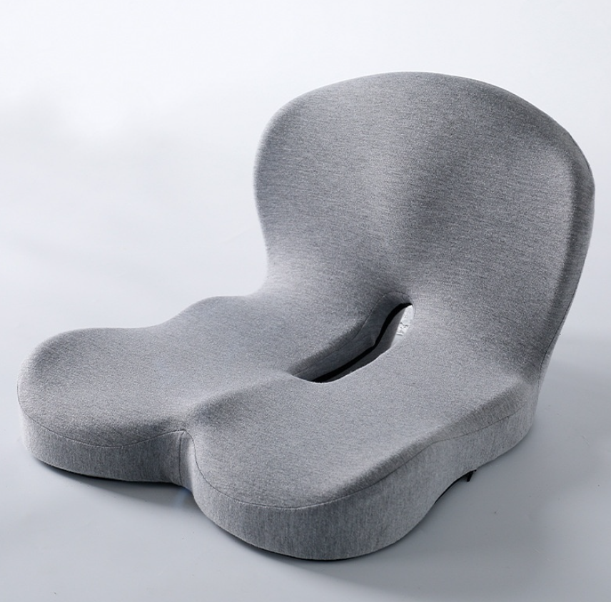 Memory foam ergonomic seat cushion with U-shaped cutout, light gray fabric.
