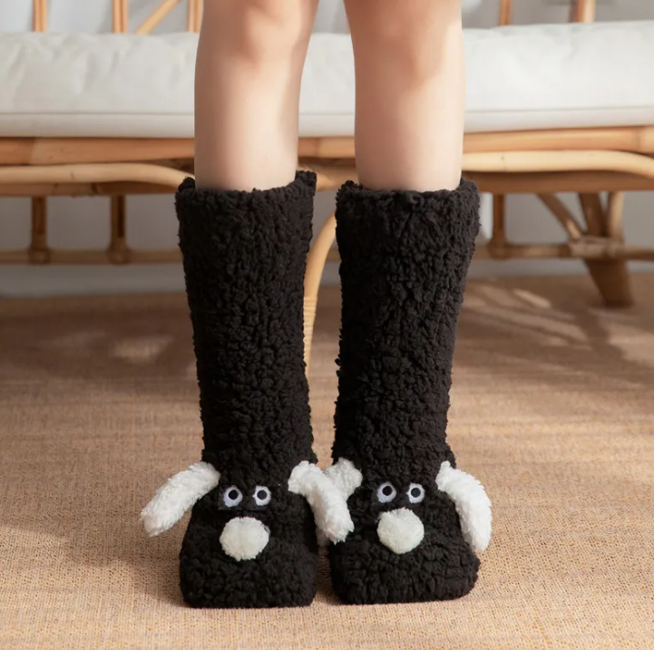 Women’s plush dog socks in black with white paw details and dog face
