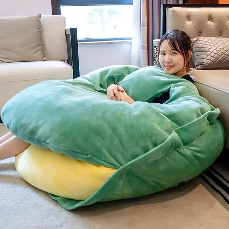 Green and yellow plush wearable turtle shell pillow wrap cushion, curled and resting