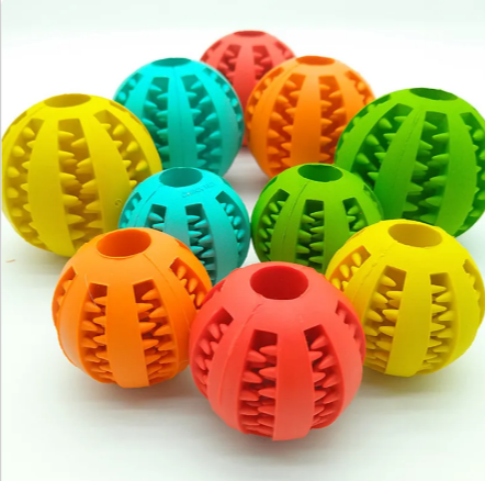 Assorted-color rubber treat-dispensing puzzle dog balls with ridged patterns