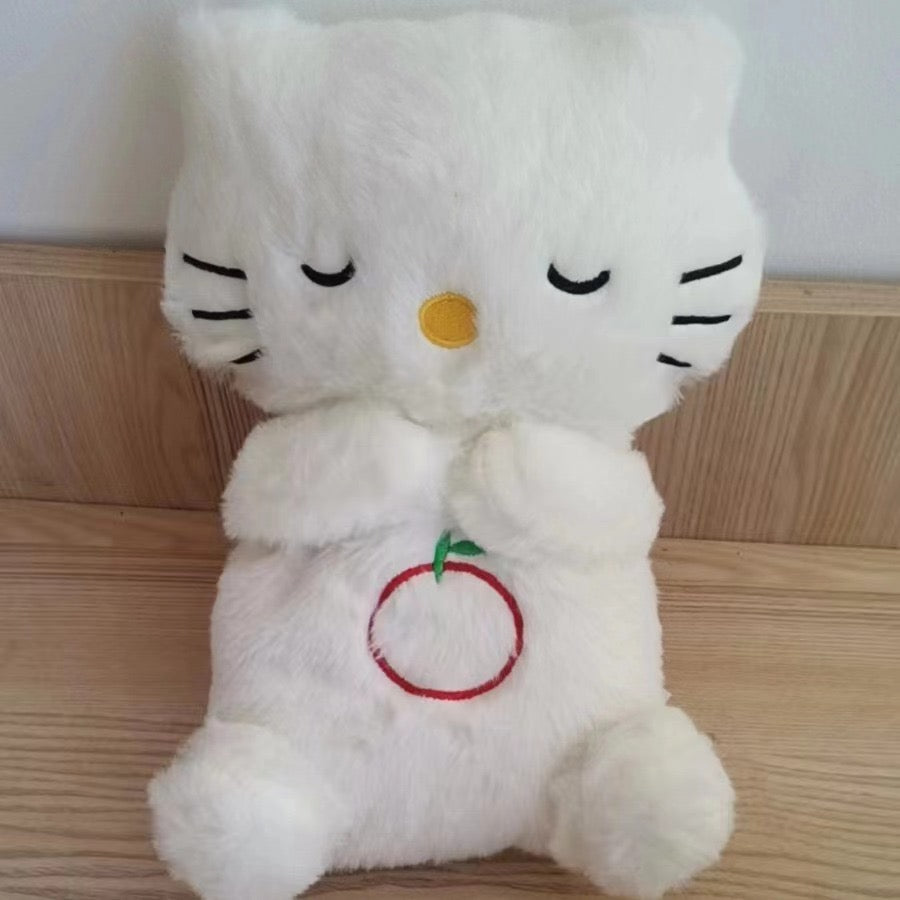 White cat plush baby sound machine, closed eyes and red heart ring belly patch.