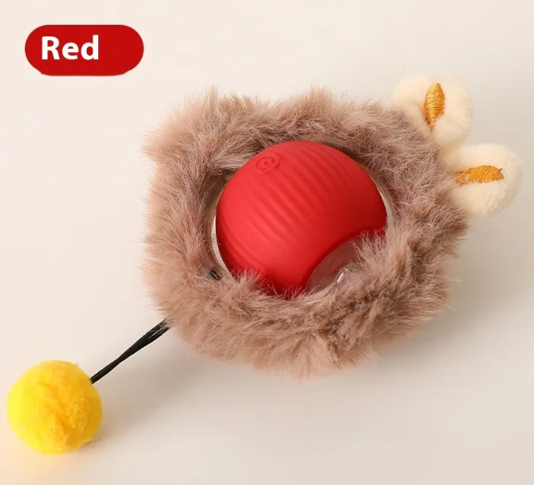 Self-rolling plush cat toy ball with red inner shell, beige fur cover, and yellow charm