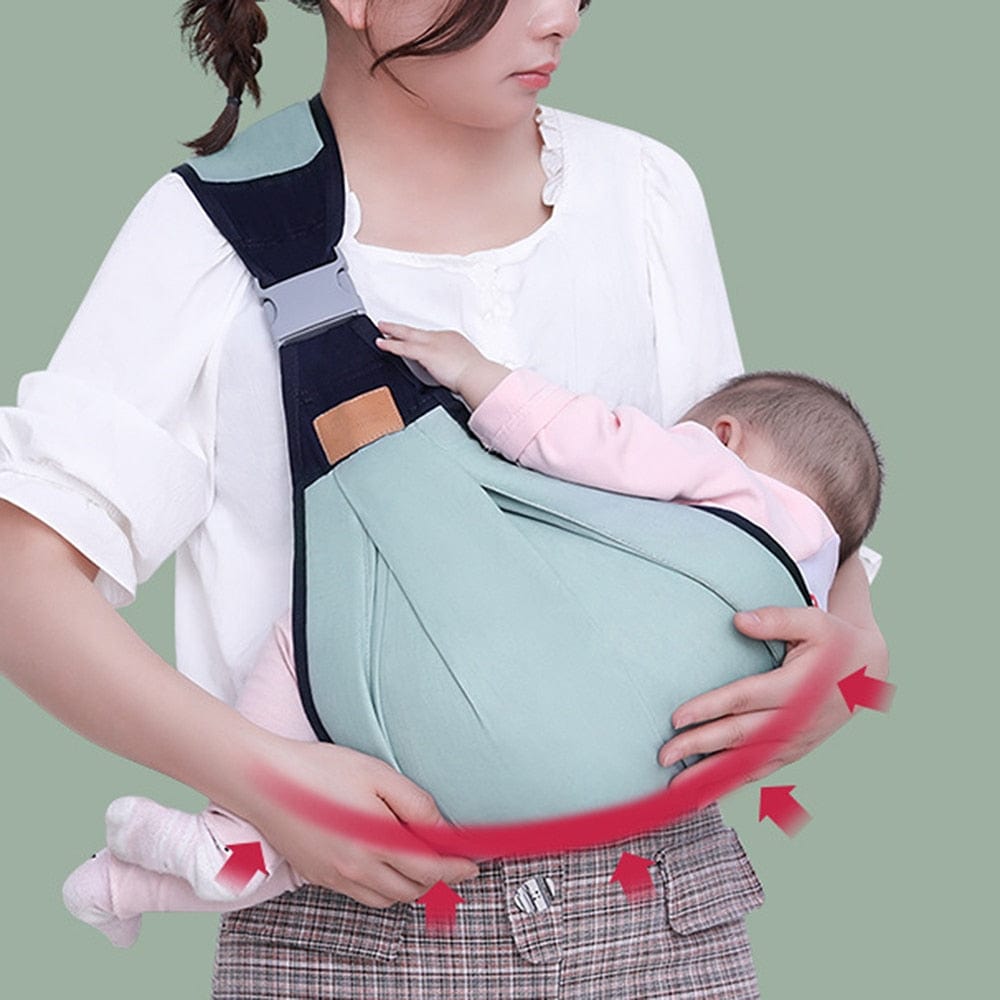 Adjustable baby shoulder carrier sling with green pouch and navy straps, baby seated.
