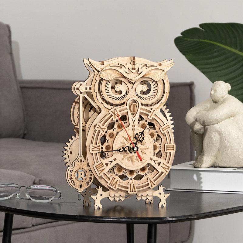 Light wood mechanical owl clock puzzle model with exposed gears and hands