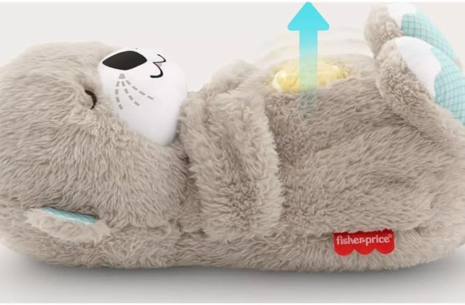 Tan plush bear sound machine with sleeping face and glowing belly light