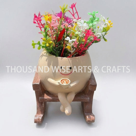 Rocking chair flower pot planter with pink, red, and green artificial flowers