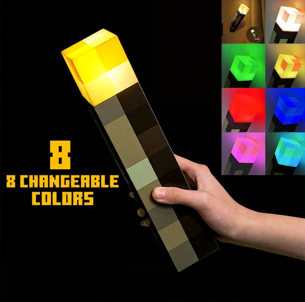 Hand holding Minecraft LED torch night light with yellow top and dark checkered body