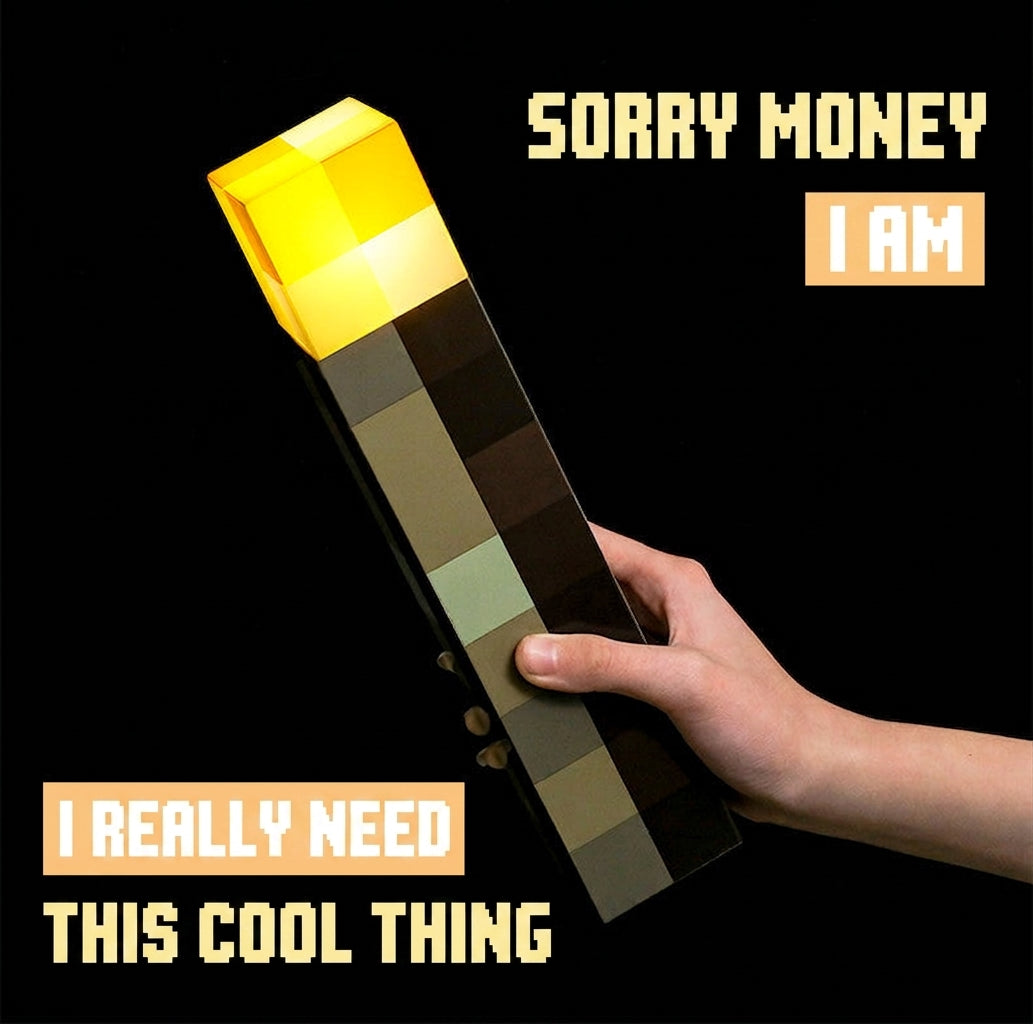 Hand holding Minecraft LED torch night light with yellow glow and dark checkered body