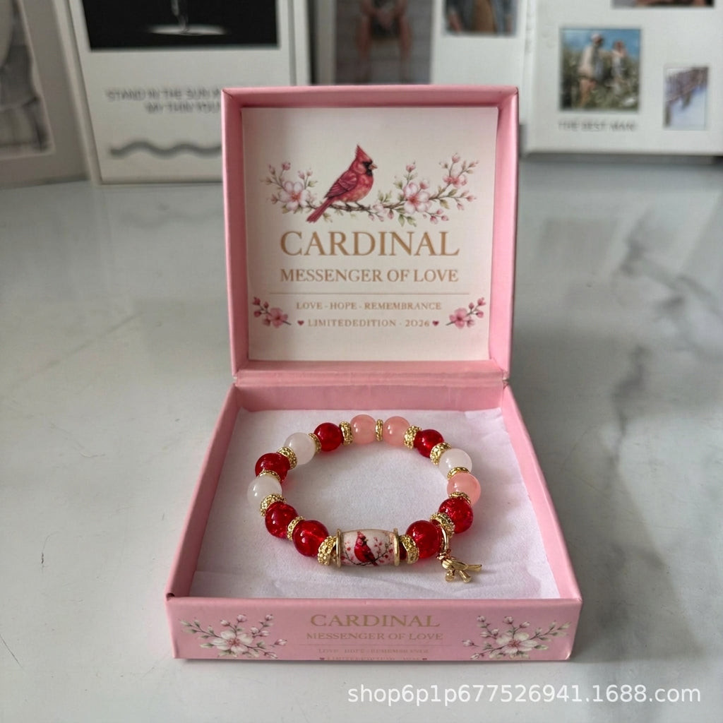 Cardinal messenger beaded elastic bracelet with red beads, pink accents, and bird charm bead
