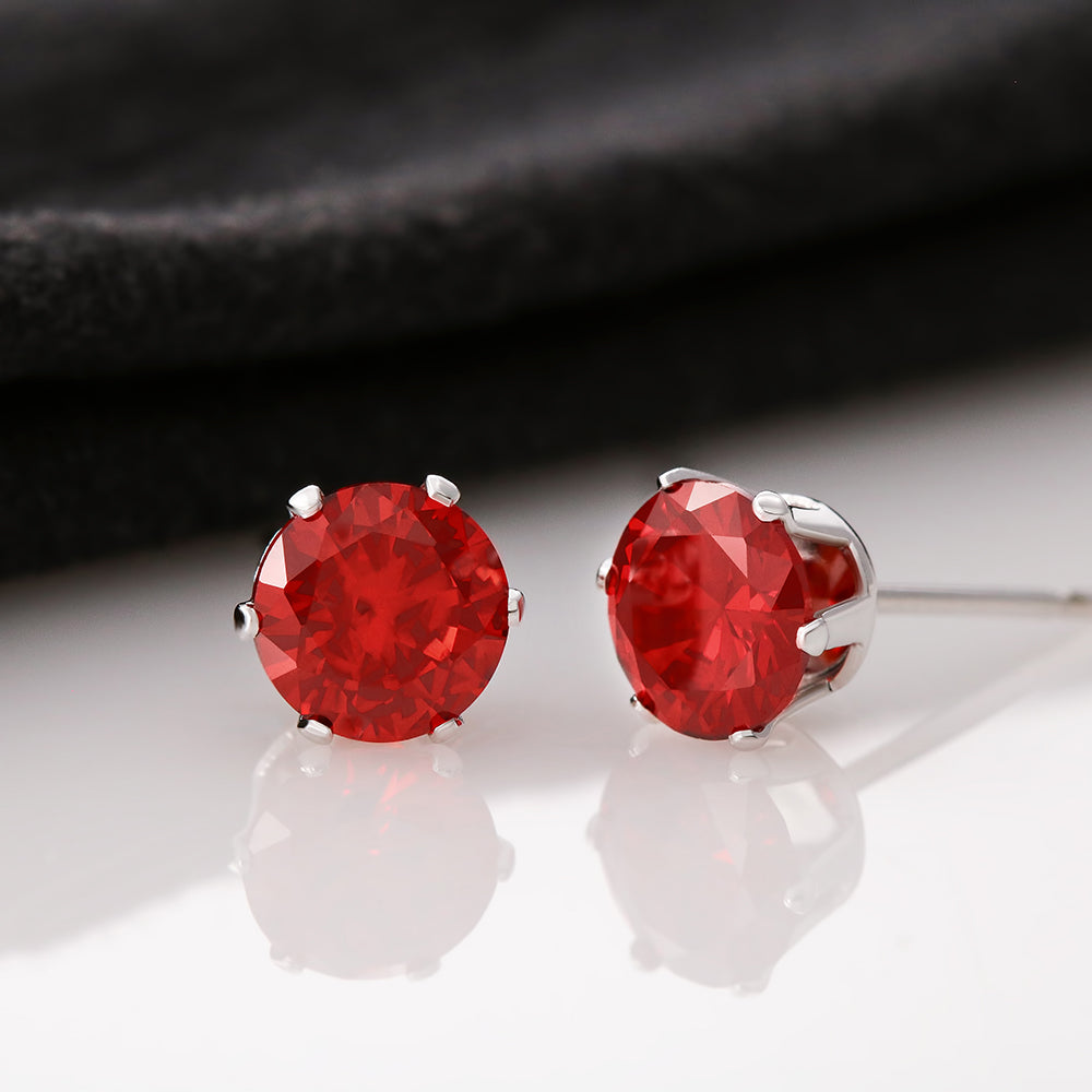 Red round cubic zirconia stud earrings in white metal settings, pair