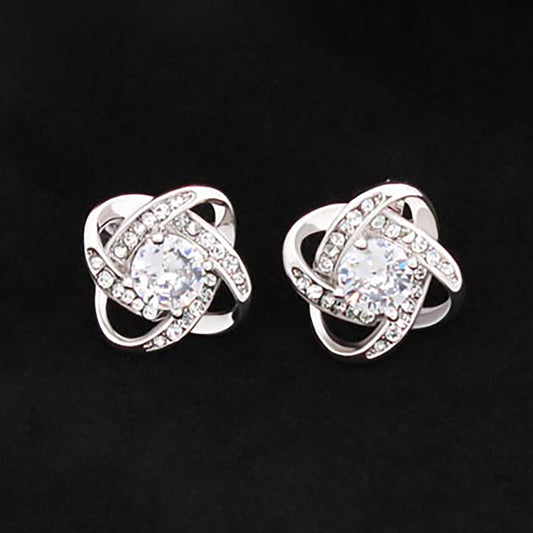Love knot stud earrings in white gold tone with oval CZ center and sparkling crystal ring.
