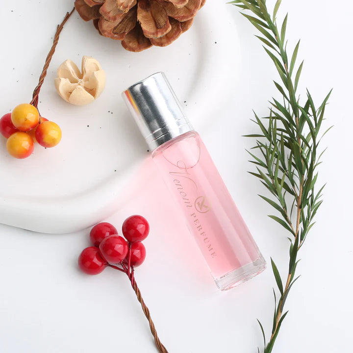 Pink perfume roller bottle with silver cap, upright