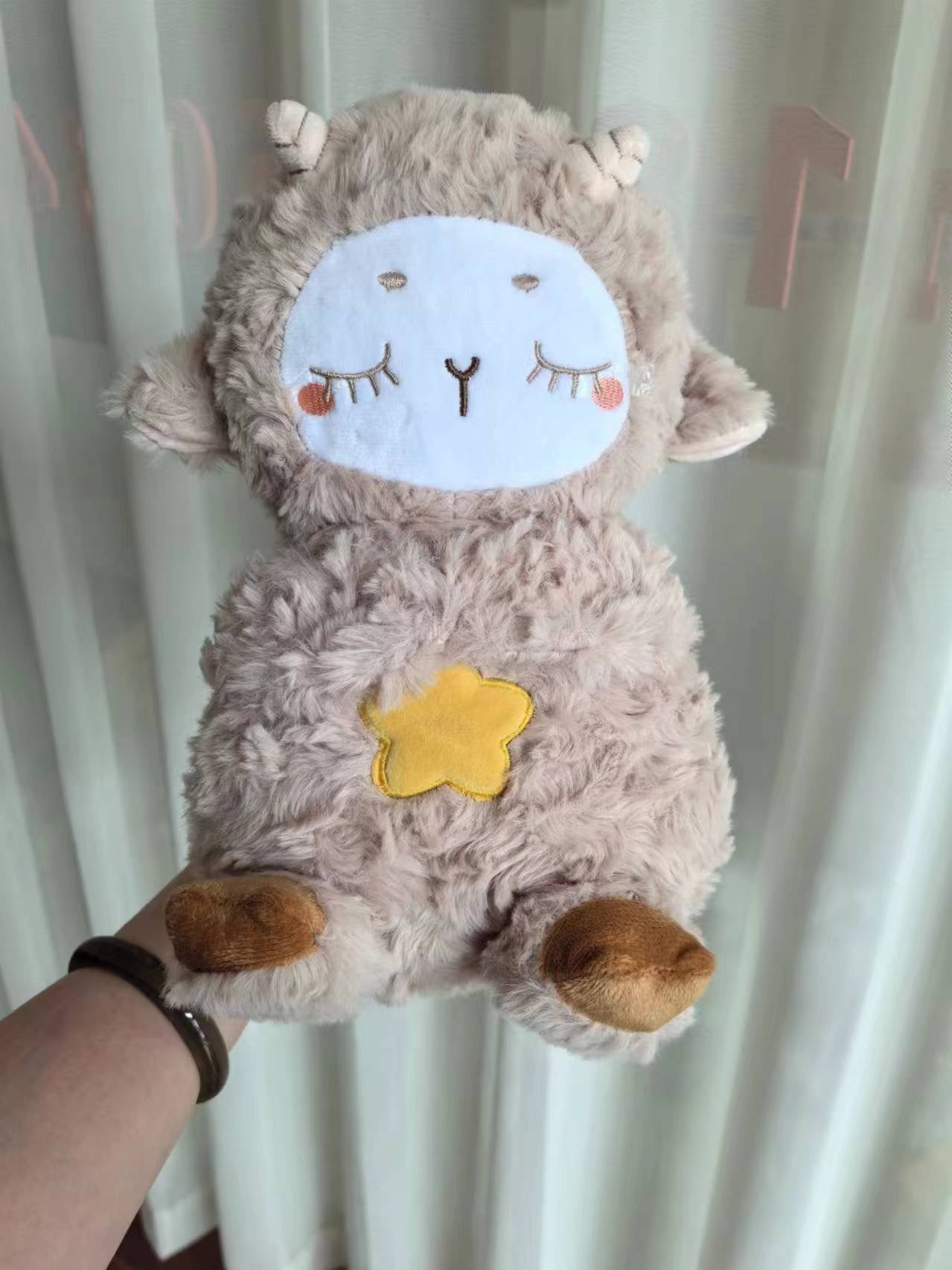 Gray plush otter sound machine with stitched face and glowing star on belly