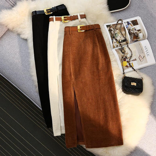 High-waist A-line corduroy skirt, brown, front slit, wide belt at waist.