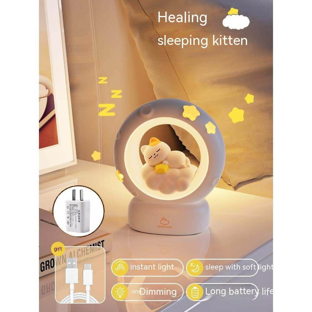 Gray bedside night light with glowing ring and sleeping kitten figure with star decals