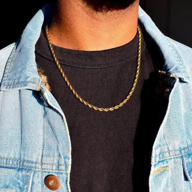 Twisted rope Figaro necklace, gold-toned chain worn at the neck over a dark T-shirt