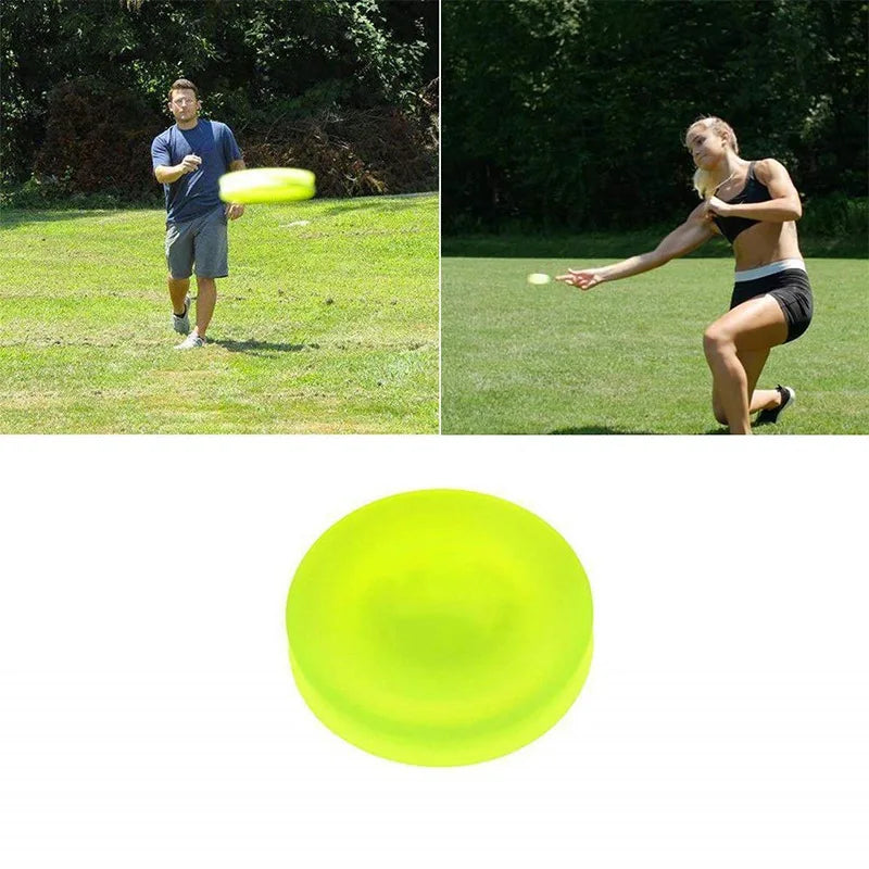 Mini flying disc game, yellow catching disc viewed from front in hand