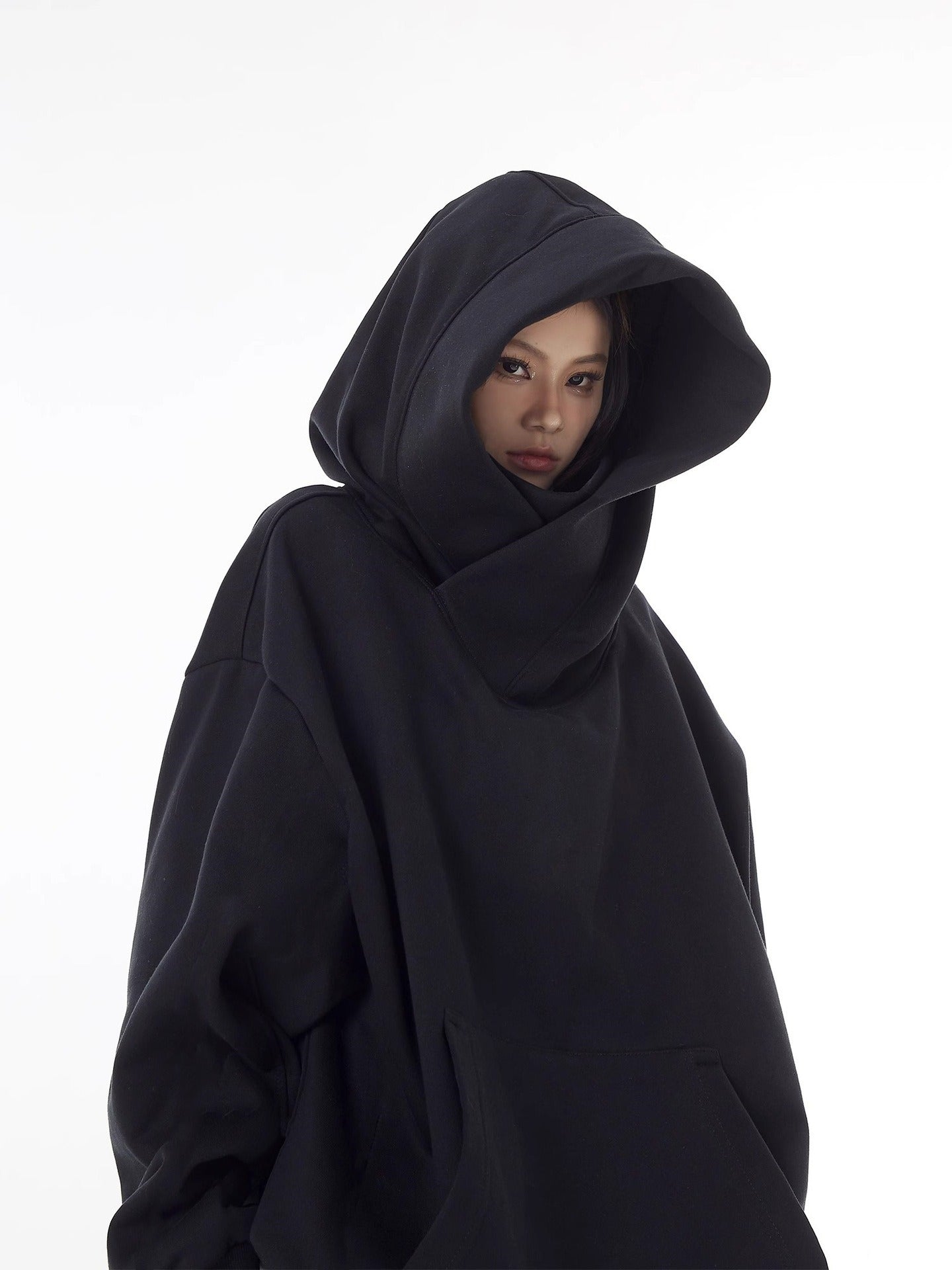 Black high-collar hoodie with oversized hood and front pouch pocket