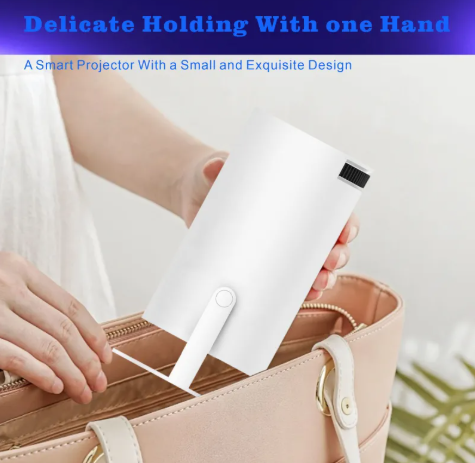 White portable projector held in one hand with front lens facing outward