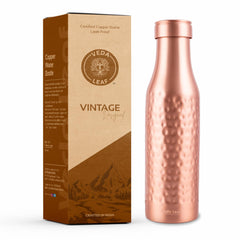 Copper water bottle with packaging on a white background