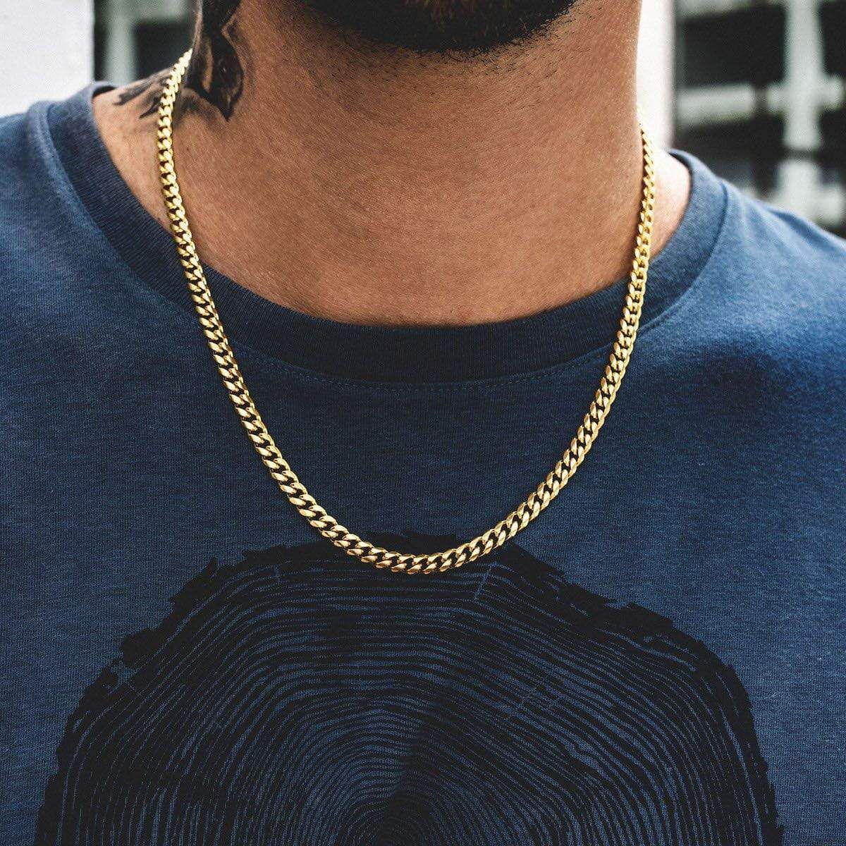 Gold-toned twisted rope Figaro necklace with dense chain links, worn around the neck