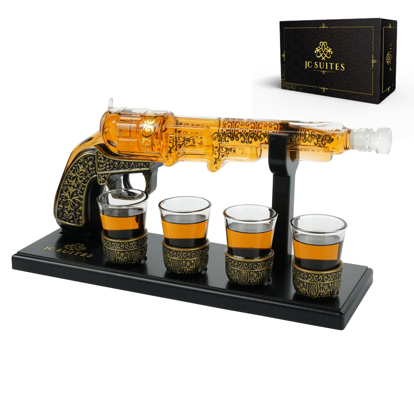 Gun-shaped decanter with stand and 4 shot glasses, plus gift box at top right.