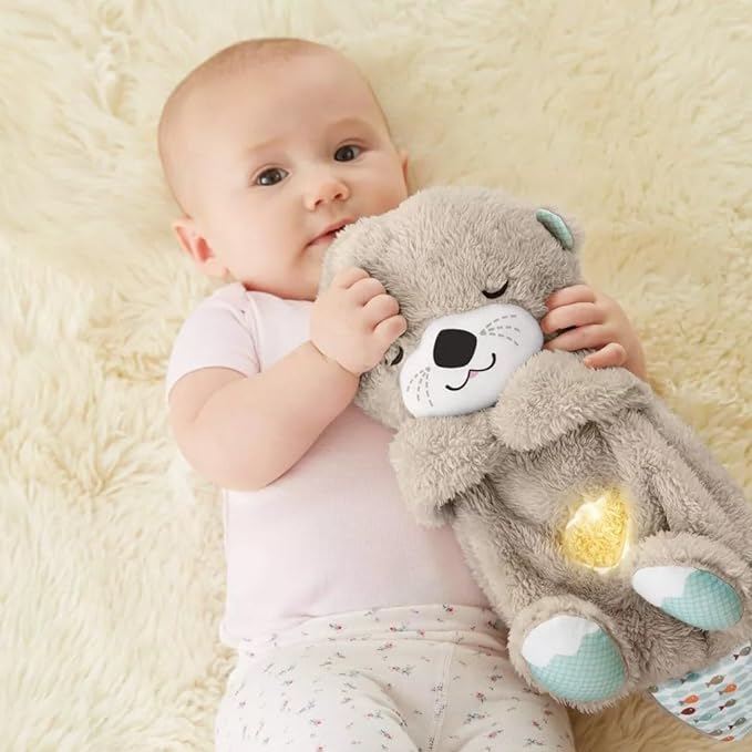 Gray plush animal sound machine with smiling face, teal paws, and glowing belly light