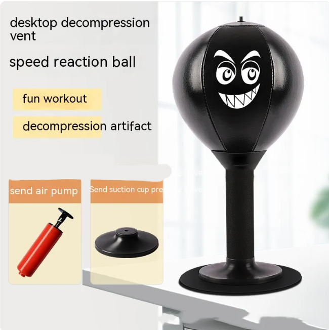 Black desktop punching reflex speed ball with cartoon face and suction-cup base