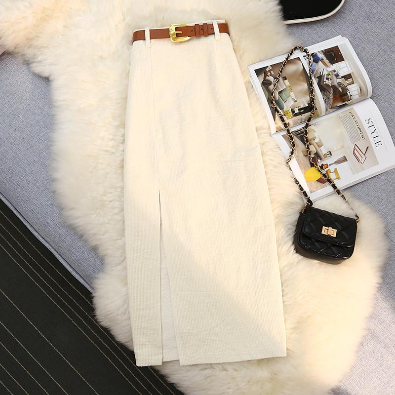 Ivory corduroy A-line midi skirt with high waist and front slit, belt at top.