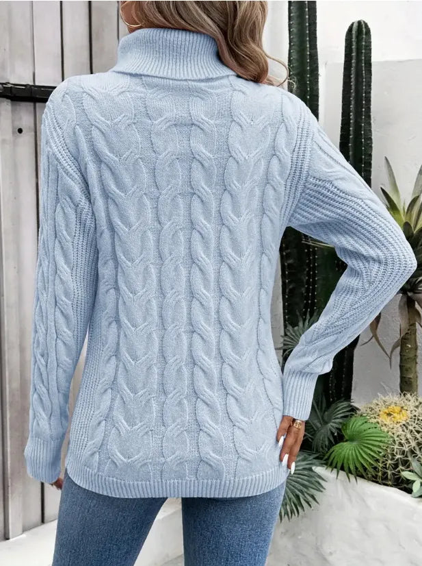 Light blue cable-knit turtleneck sweater shown from the back with long sleeves