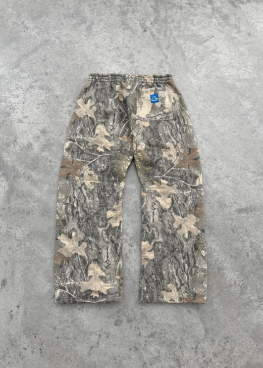Camouflage jogger pants with elastic waistband, side pockets, and small chest tag.