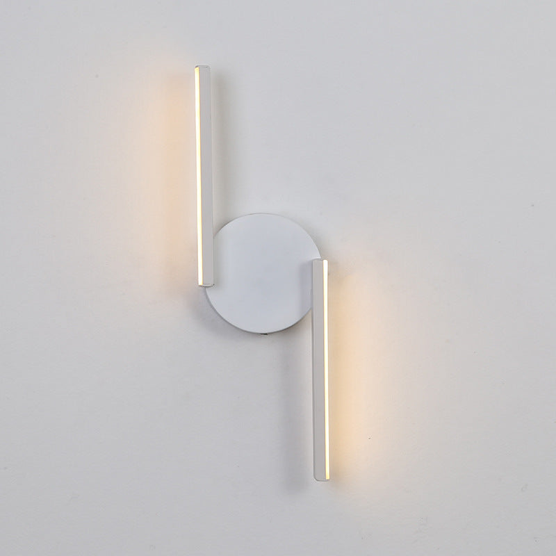 Wall sconce with round backplate and two slim vertical LED bars, white finish, side view