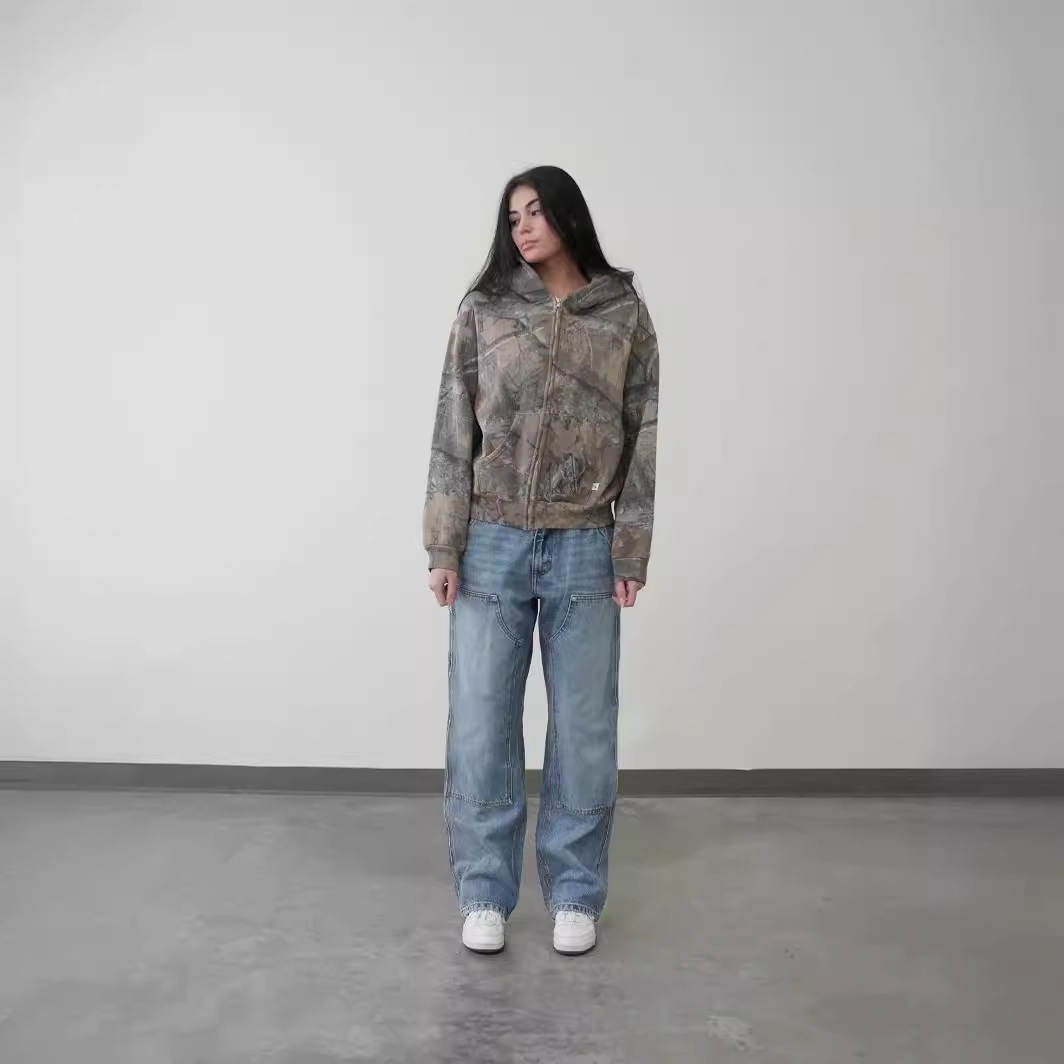 Camouflage zip-up hoodie on model, attached hood and zipper front, gray tan print