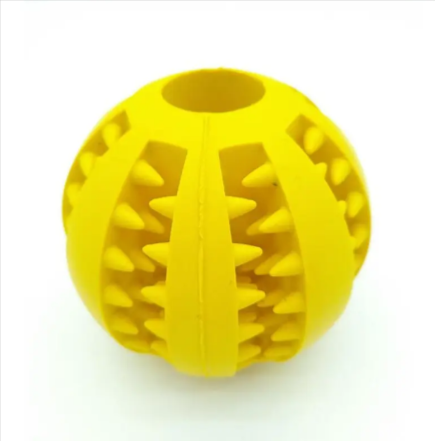Dog treat dispensing rubber ball in bright yellow with raised spike pattern