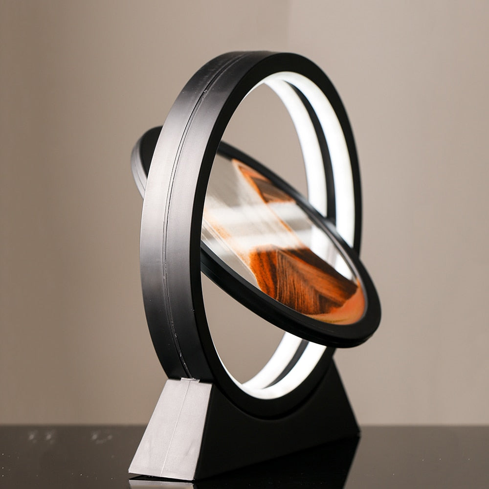 Sand art landscape table lamp shown at an angle, orange sand in a glowing ring