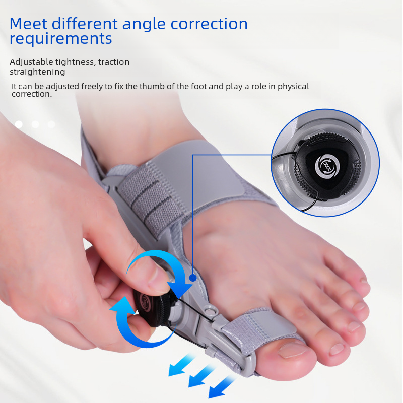 Gray adjustable bunion corrector brace on foot with strap adjustment and traction knob