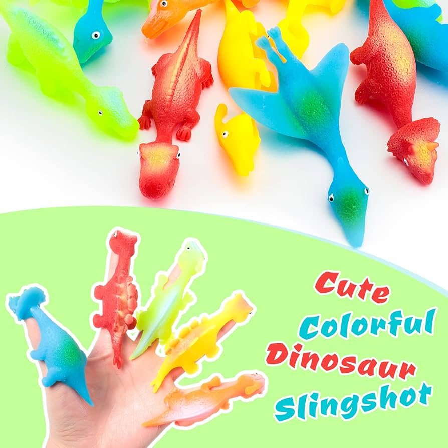 Colorful dinosaur slingshot finger toys scattered on a light background