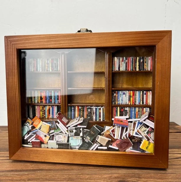 Brown wooden bookcase cabinet with glass doors, books visible through the panels