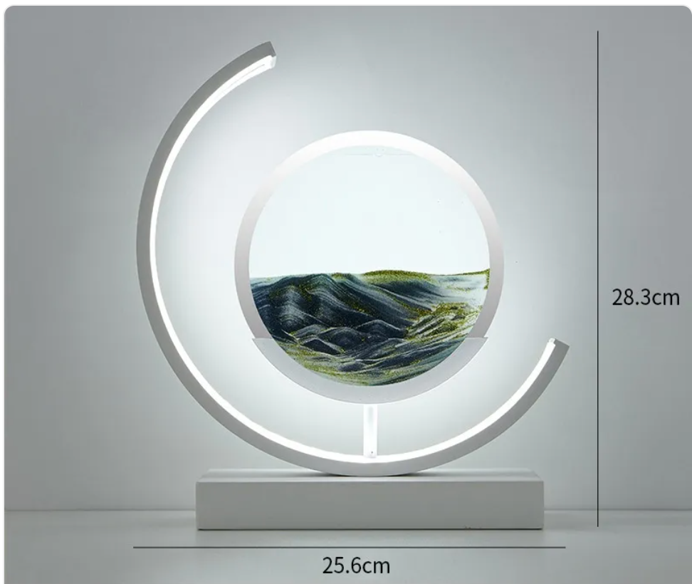 Hourglass-style table lamp with crescent LED ring and dark green glass insert, white base