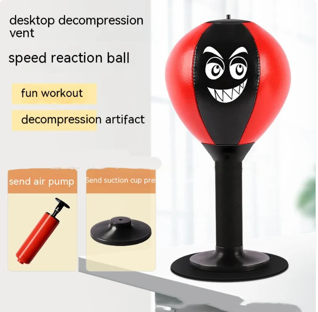 Red desktop punching reflex speed ball with cartoon face and suction-cup base