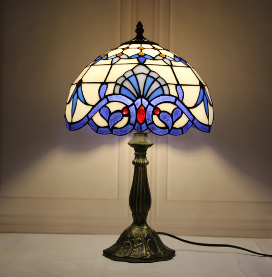 Stained glass bedside table lamp with blue fan-pattern shade and dark bronze base