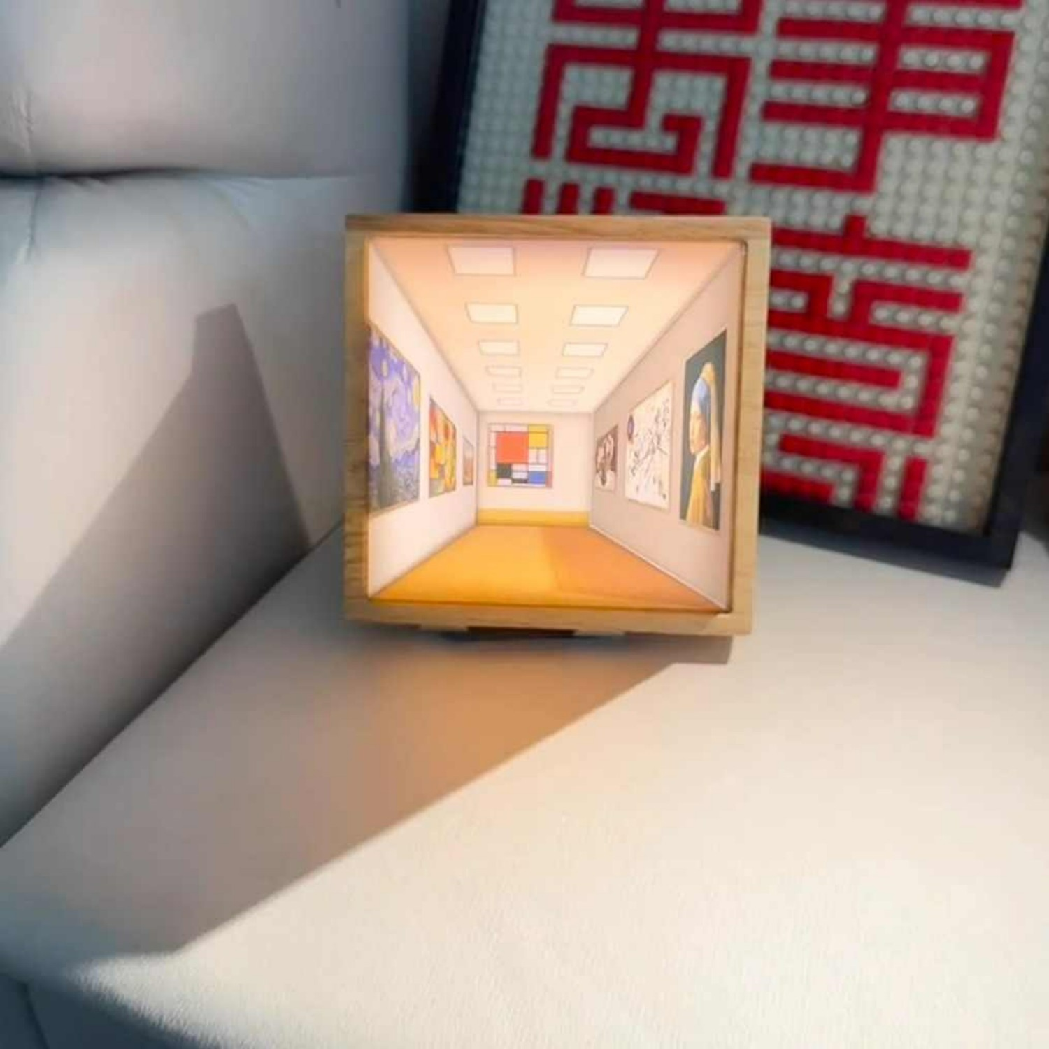 Wooden framed LED night light on tabletop showing a glowing 3D room scene