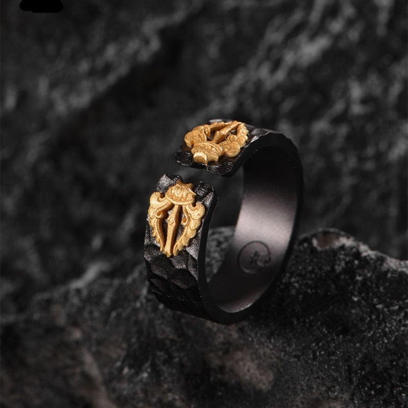 Black adjustable ring with raised gold central geometric emblem