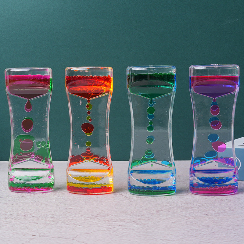 Two-color liquid hourglass timer with red top and yellow bottom, floating colored beads